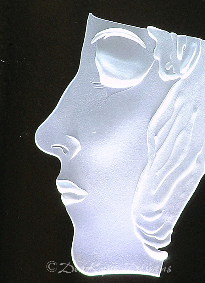Sculpted carved glass face